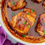 A corner of a pot cooking Filipino chicken adobo with coconut milk.