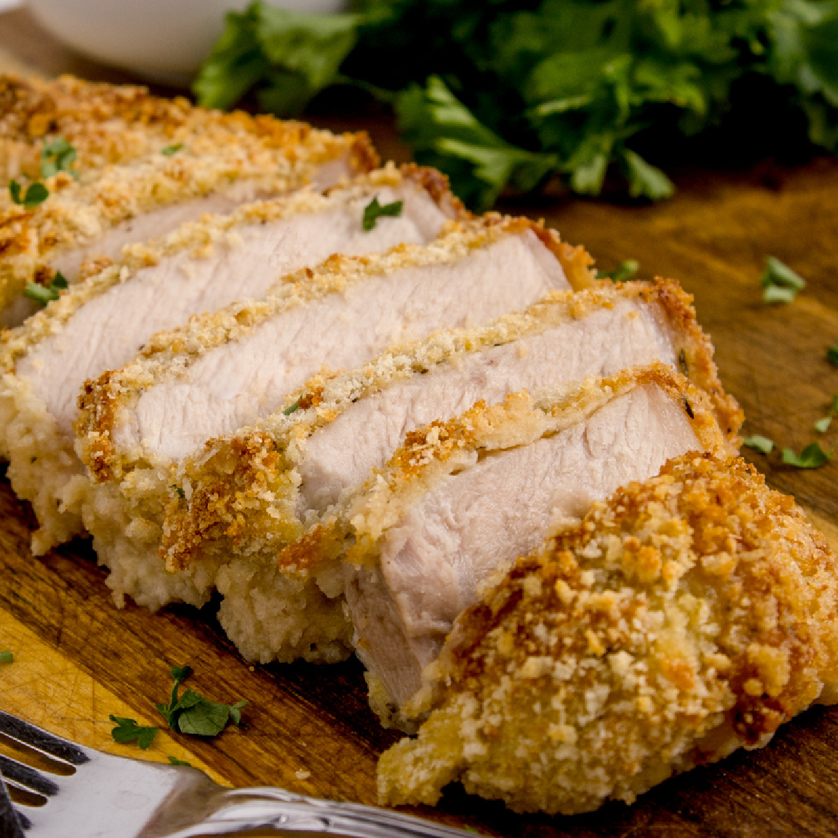 slices of Parmesan Crusted Pork Chops on a serving tray