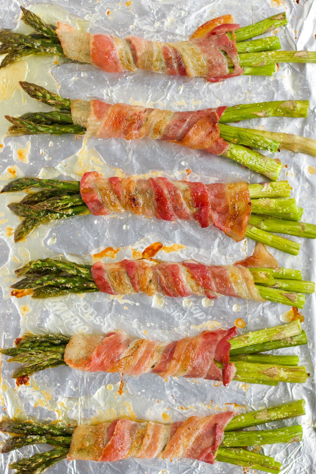 Bacon-wrapped asparagus cooked on a basking sheet.