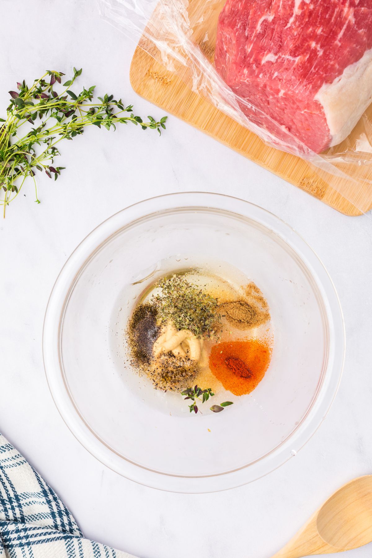 Mustard and spices combined in a small mixing bowl.