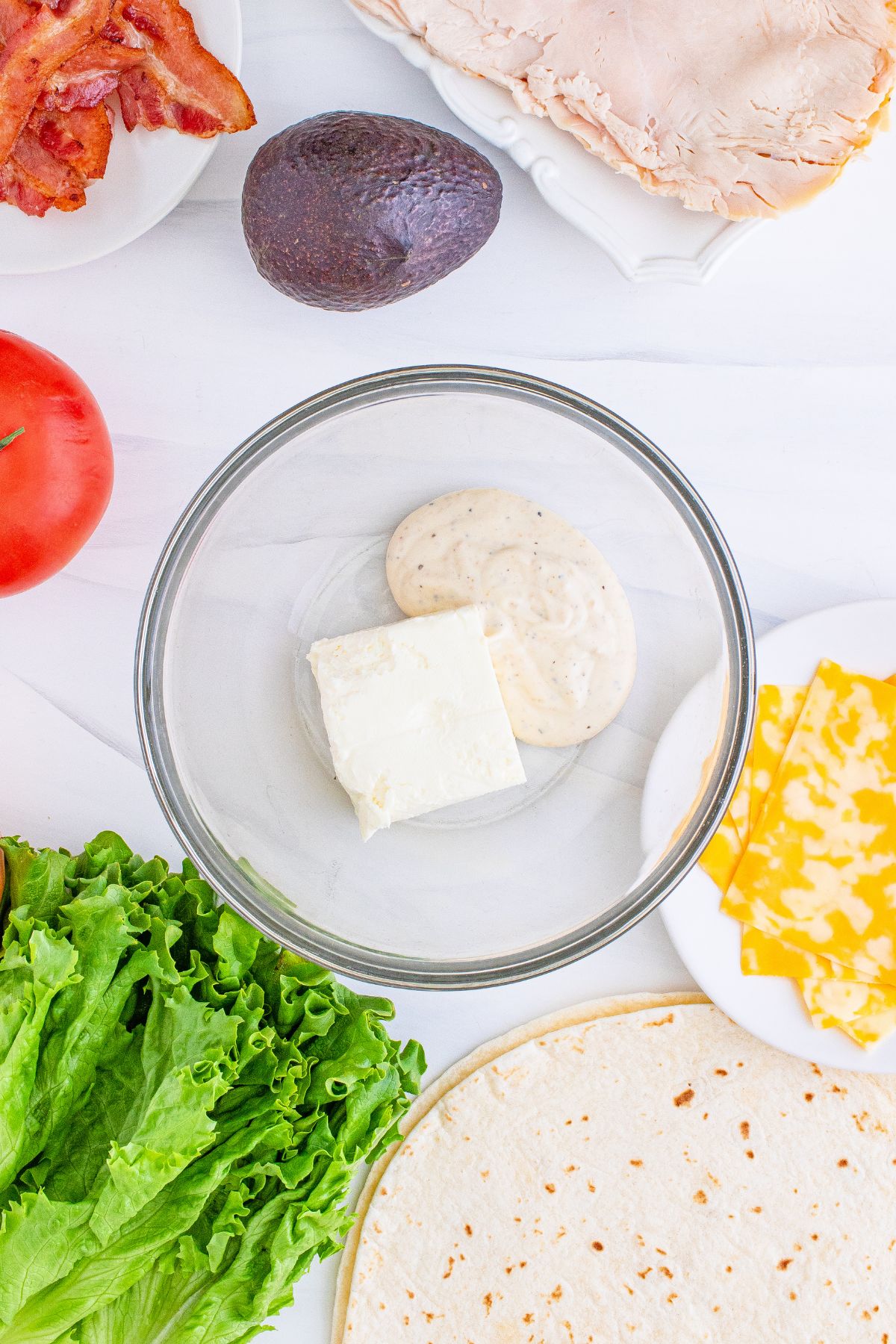 Cream cheese and mayonnaise in a small mixing bowl.