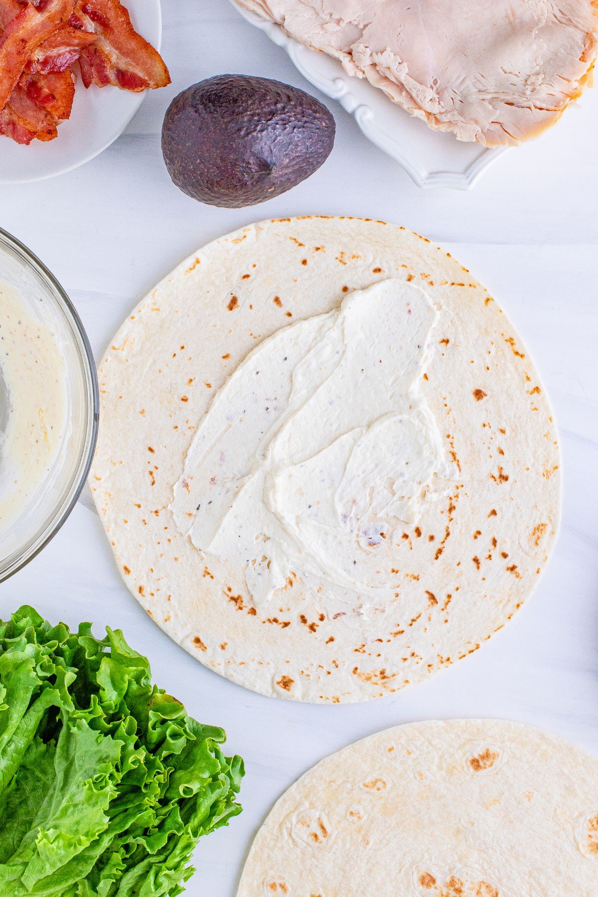 The cream cheese mixture onto the tortilla.