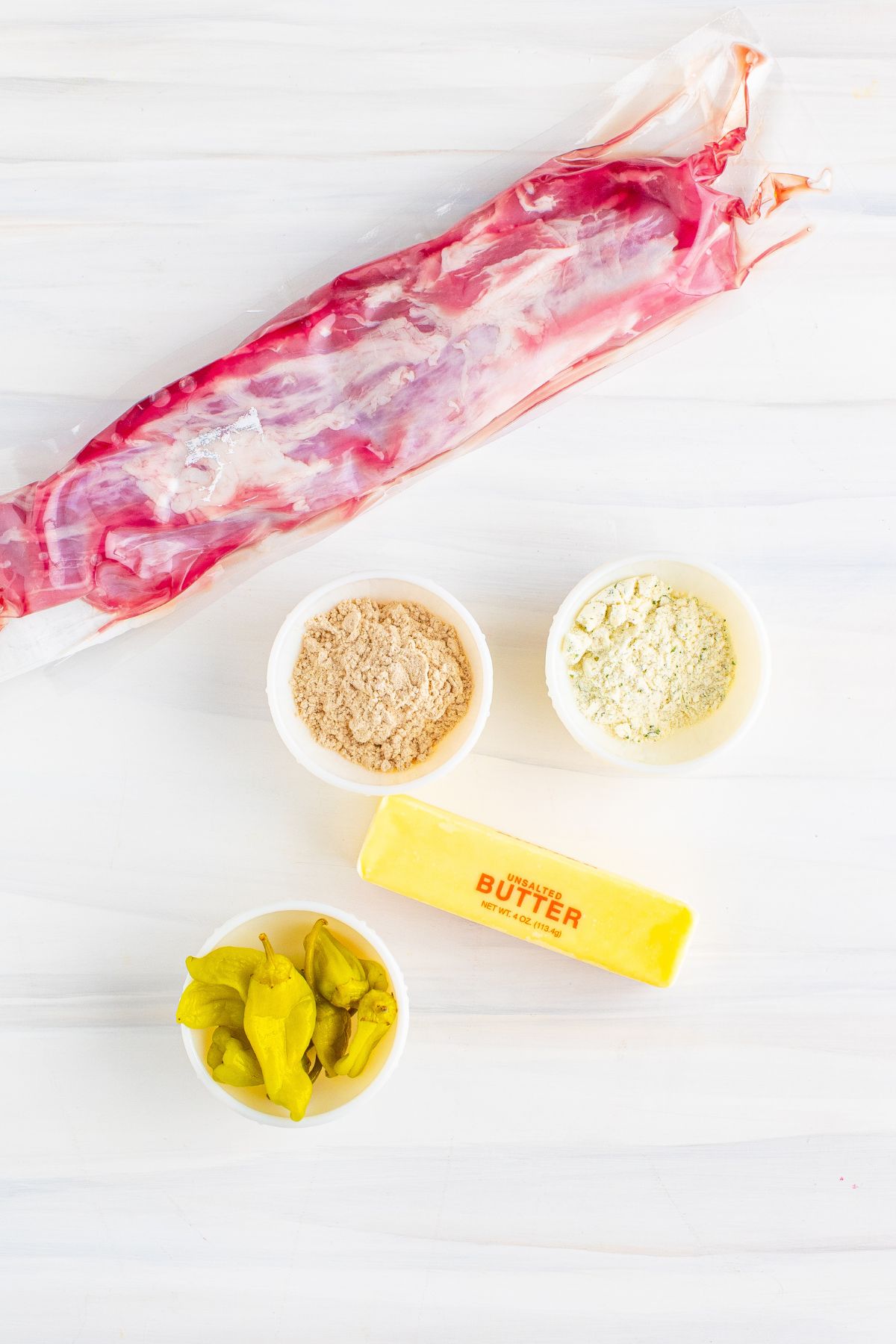 Ingredients to cook Mississippi pork tenderloin on a table.