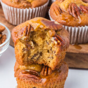 A pecan muffin missing a bite on top of another whole muffin.