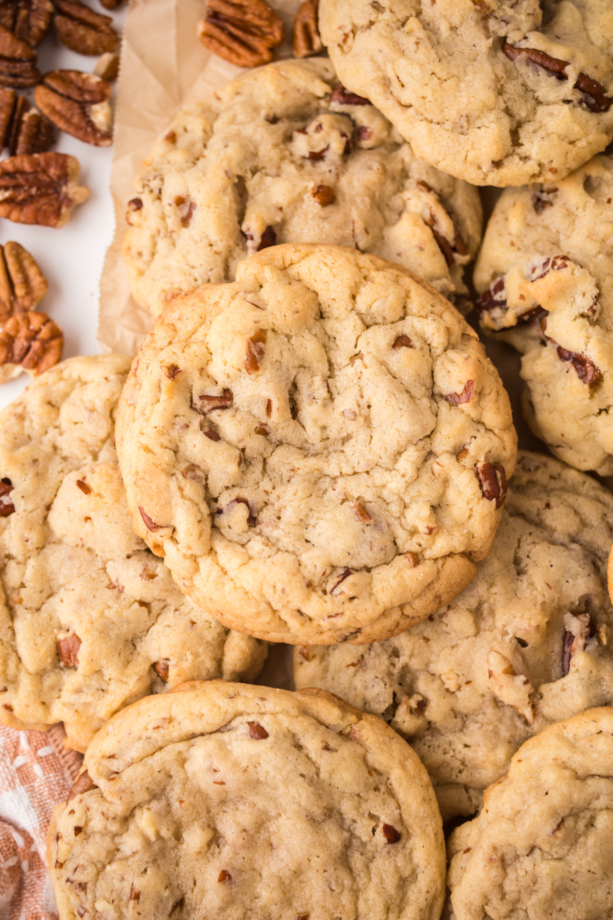 Cookies with pecans stacked on top of one another.