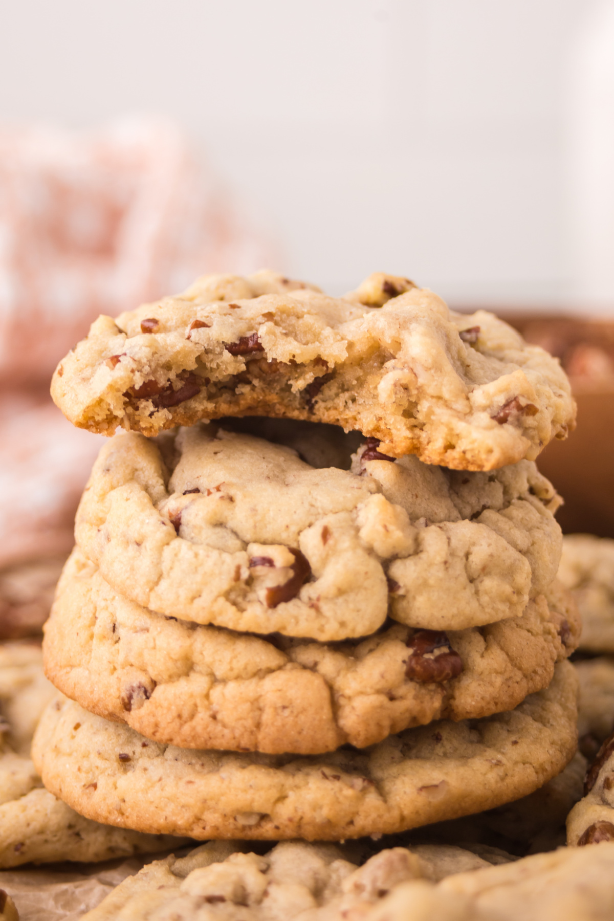 A stack of cookies with a bite taken out of the top cookie.