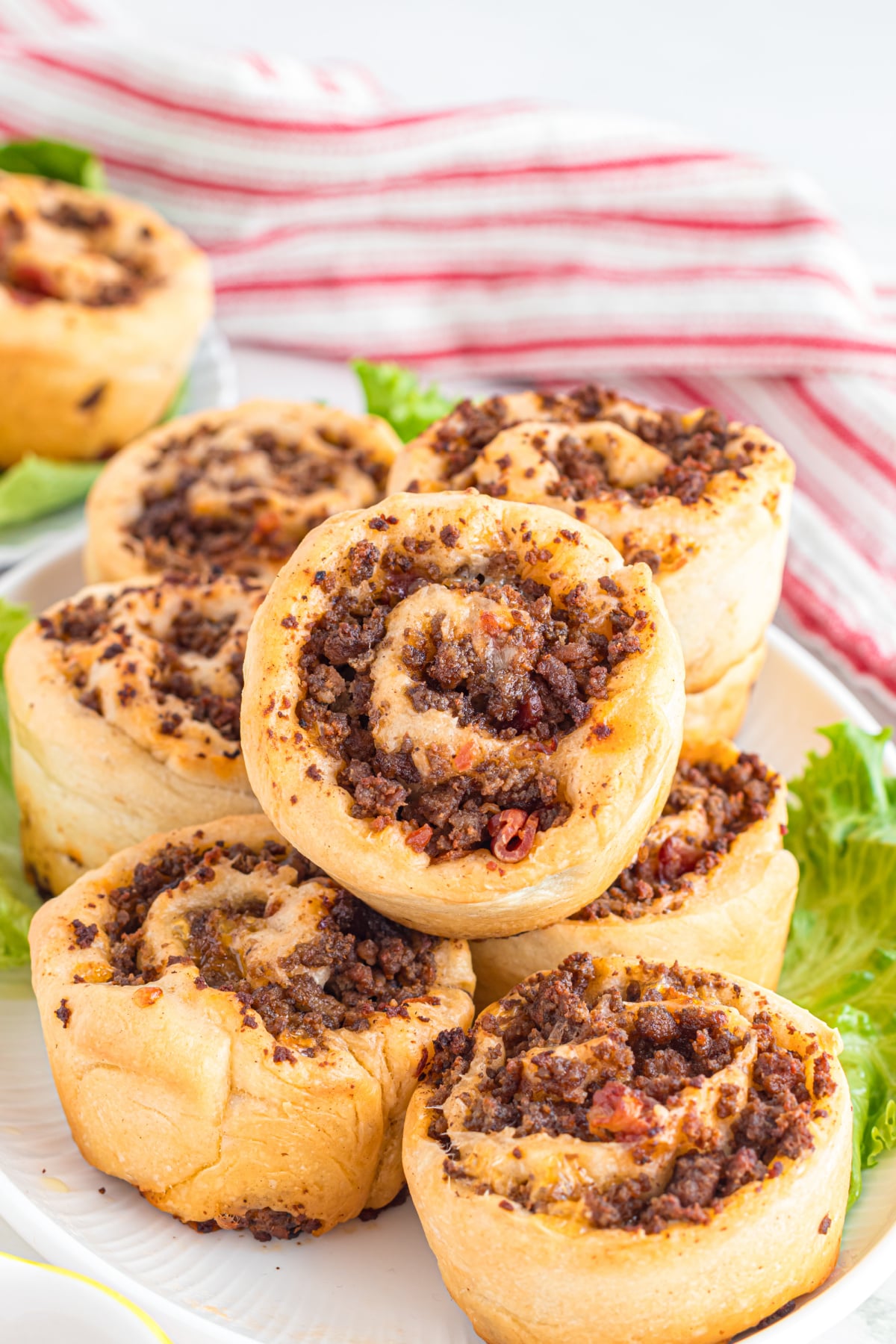 A plate filled with hamburger pinwheels.