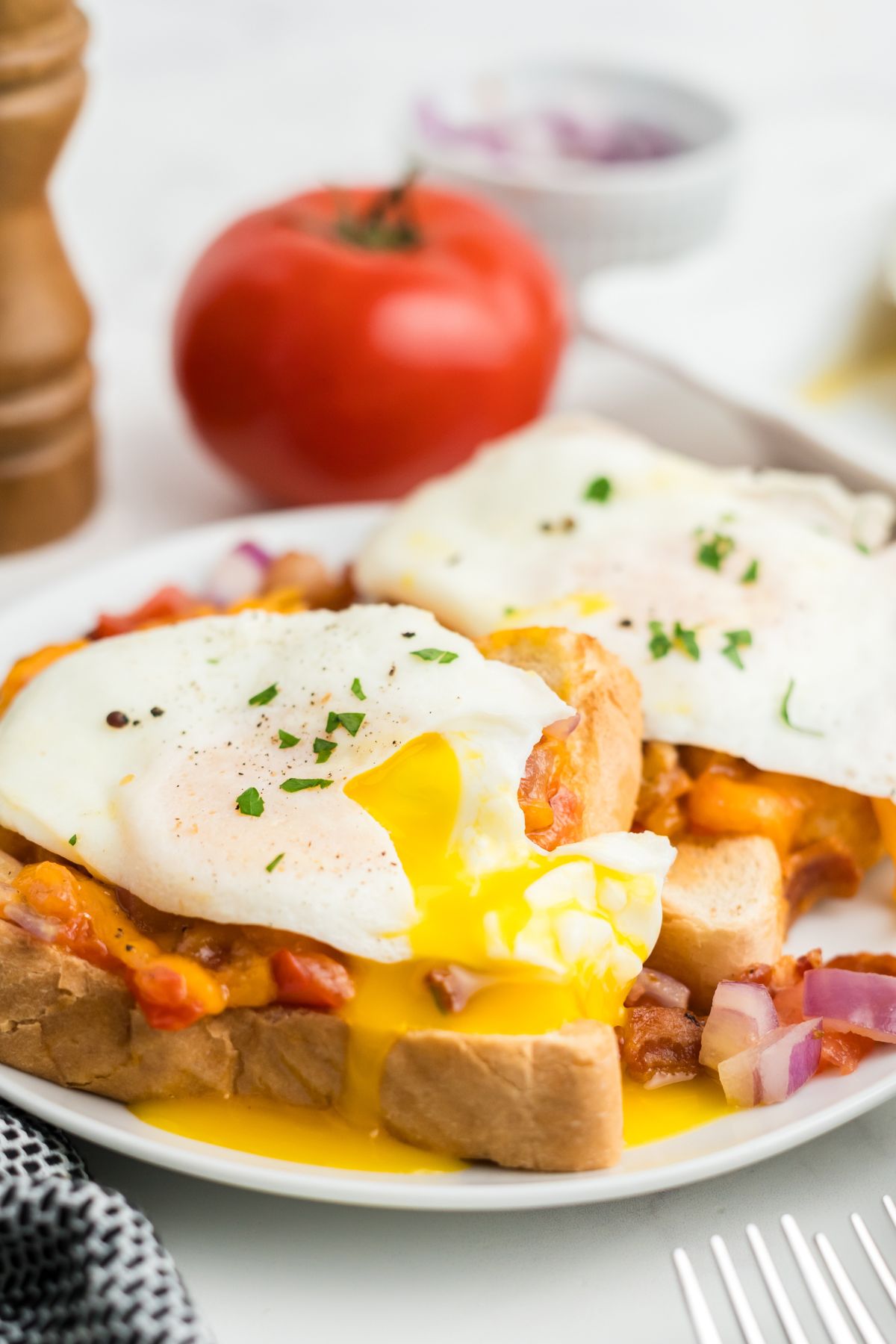 Easy cheese toast with an egg and the yolk running down the bread.