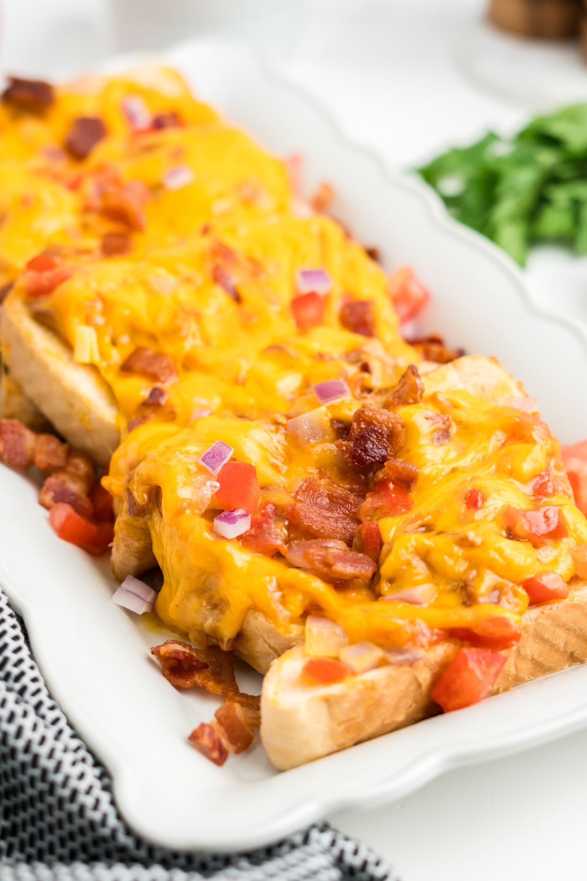 Melted cheese, veggies and bacon over toast.