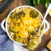A serving of crockpot chicken broccoli rice in a bowl with a fork lying on top.
