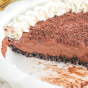 A chocolate mousse pie with a slice missing.
