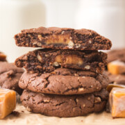 Chocolate caramel cookies stacked on top of one another.
