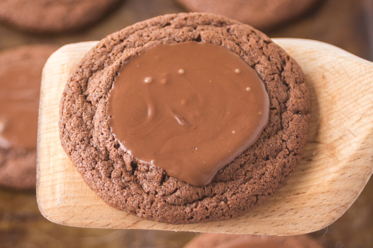 Nutella filled cookie on a wooden spatula