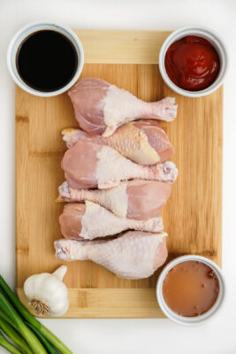 Ingredients to make chinese drumsticks on a cutting board.