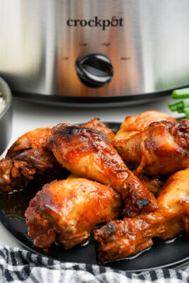 Plate of honey chicken drumsticks on a plate.