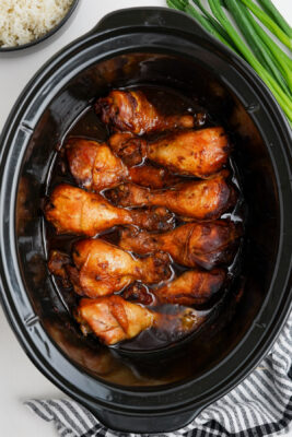 Chicken drumsticks cooked and ready to eat inside the slow cooker.