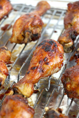 Cooked asian chicken drumsticks on the cooking tray.