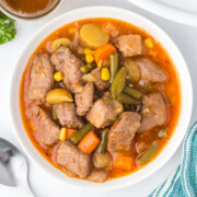A bowl of beef and beer stew on a table.