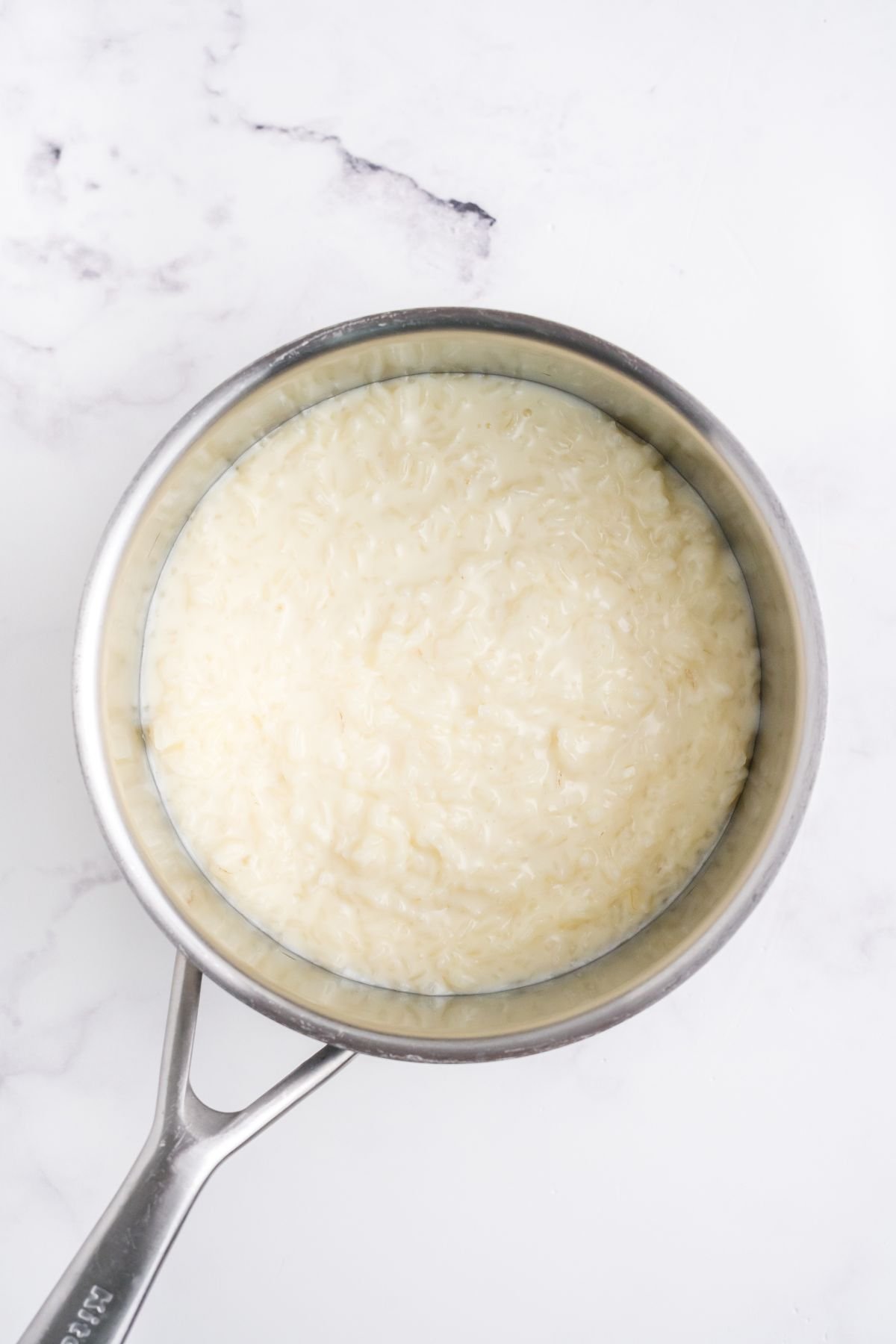 Rice pudding mixture cooking in a pot.