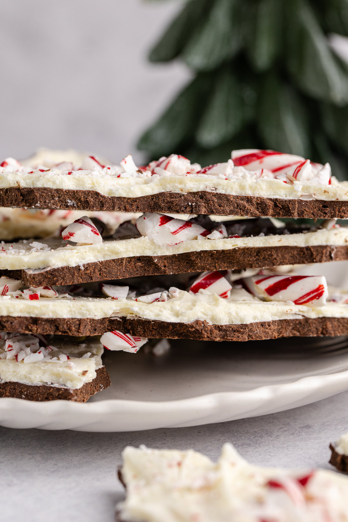 Peppermint bark with layers of white and dark chocolate on a plate.