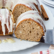A slice of Pumpkin Spice Bundt Cake being lifted from the platter.