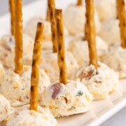 Mini cheese balls on a serving platter.
