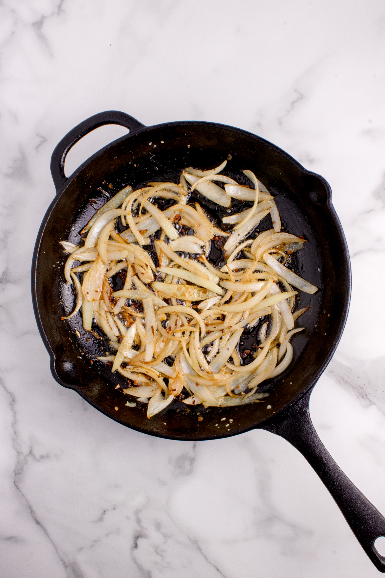 Onions and garlic sauted in a cast iron skillet.