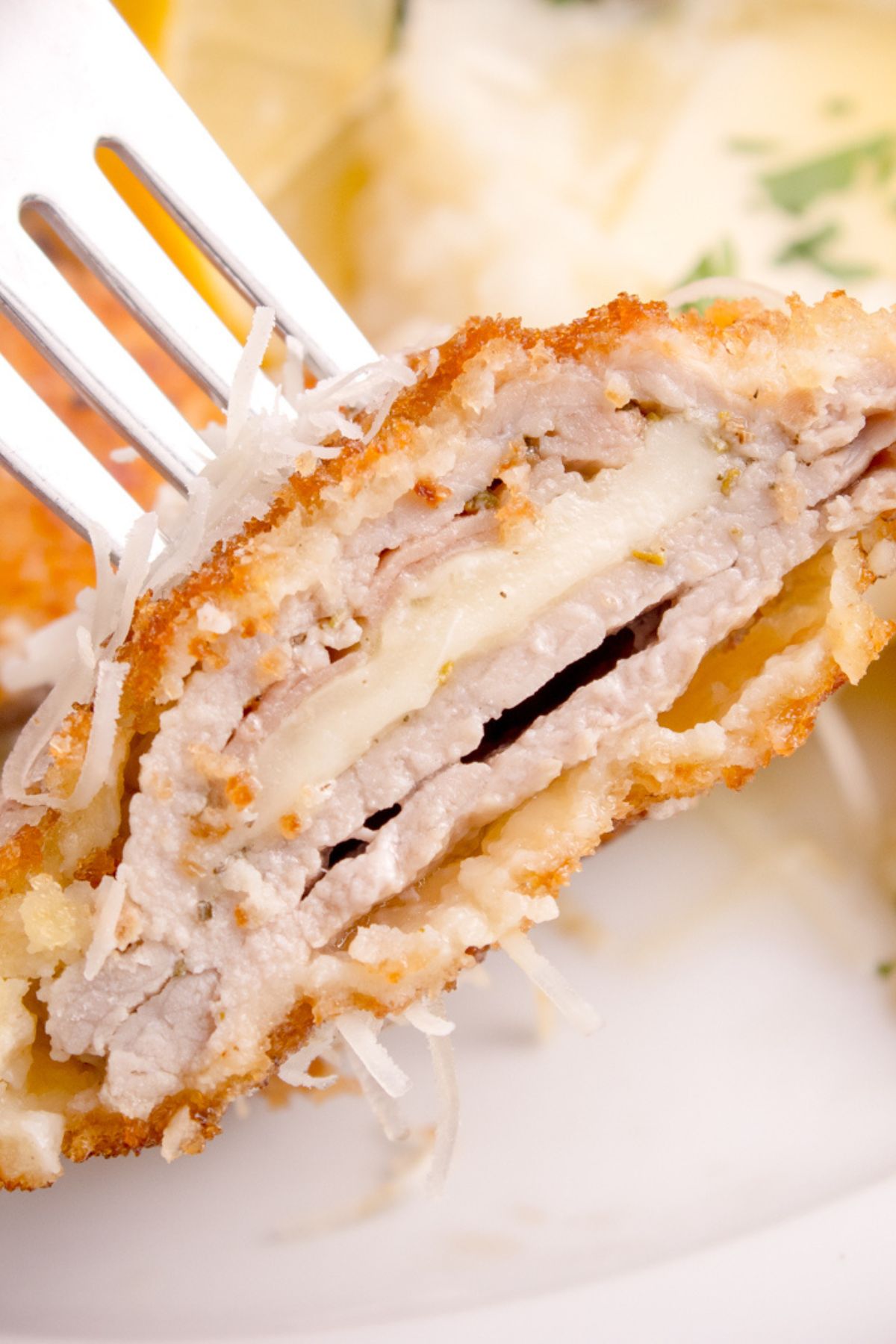 A piece of stuffed veal cutlets on a fork.