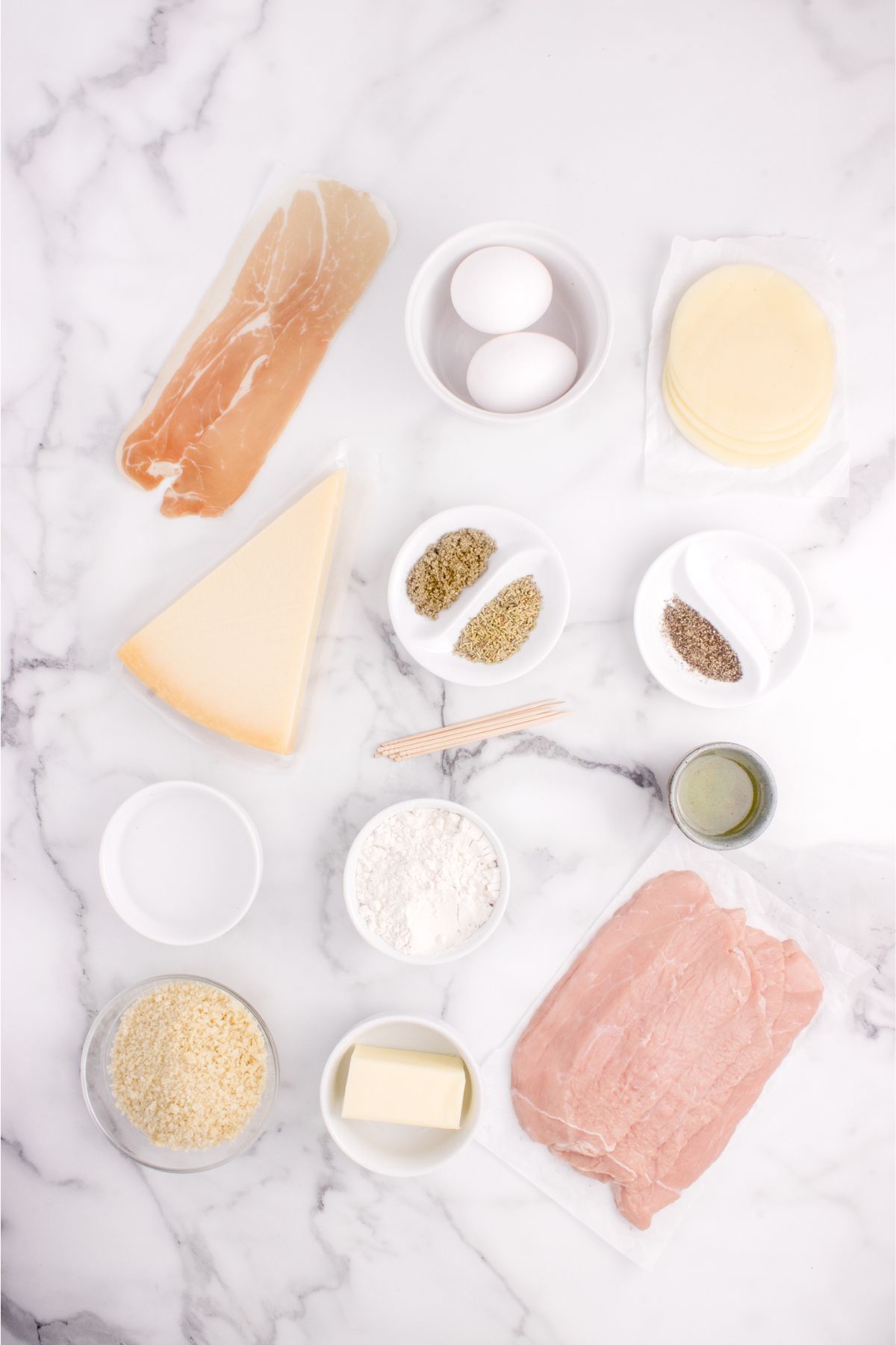 Ingredients of stuffed veal cutlets on a table.