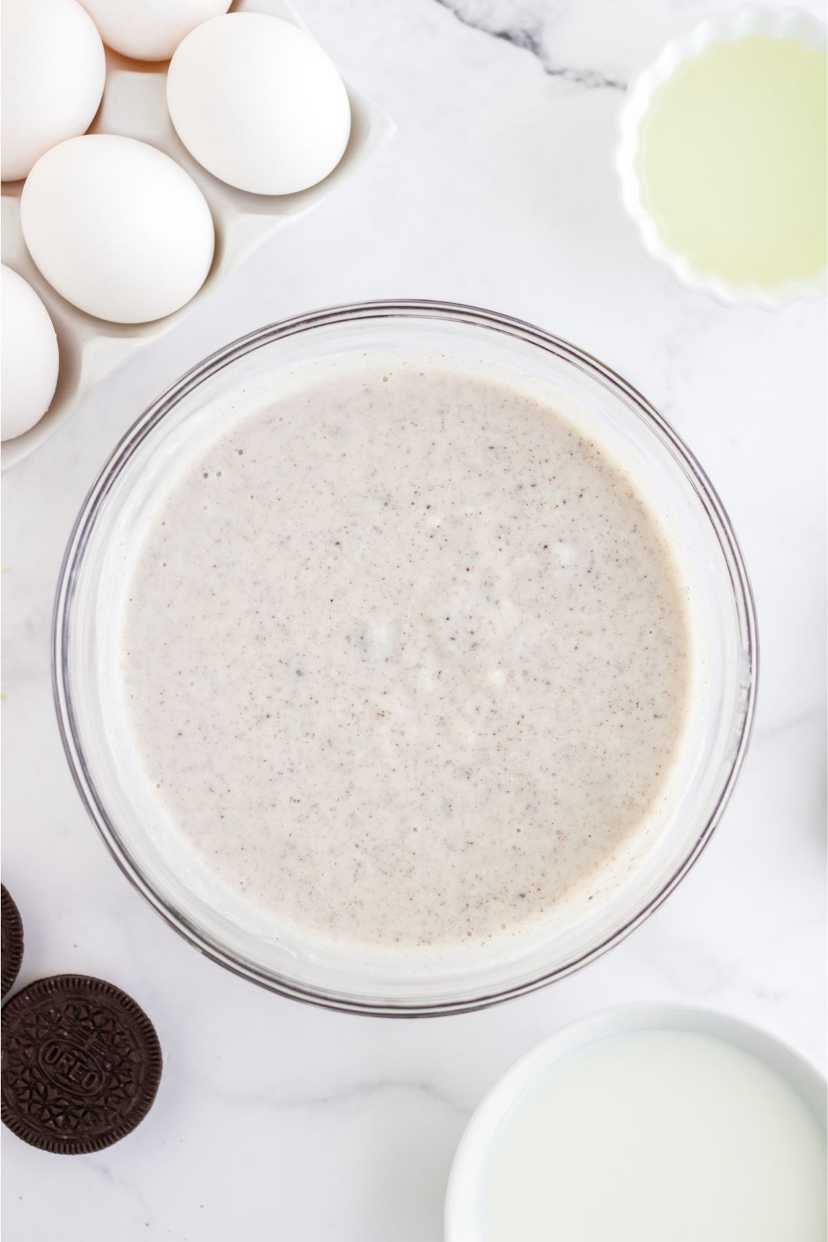 Pudding mix and milk combined in. a bowl.