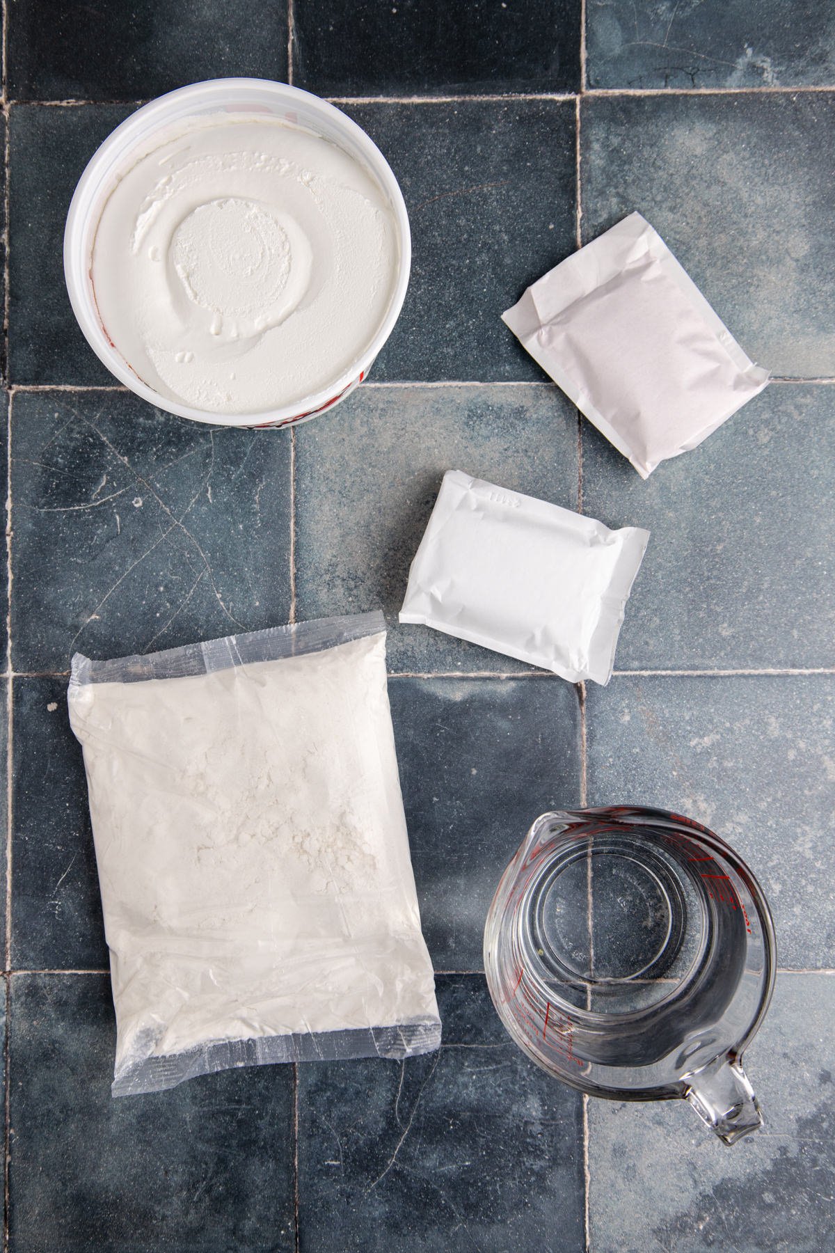 Ingredients to make a Jello poke cake laid out on a counter.