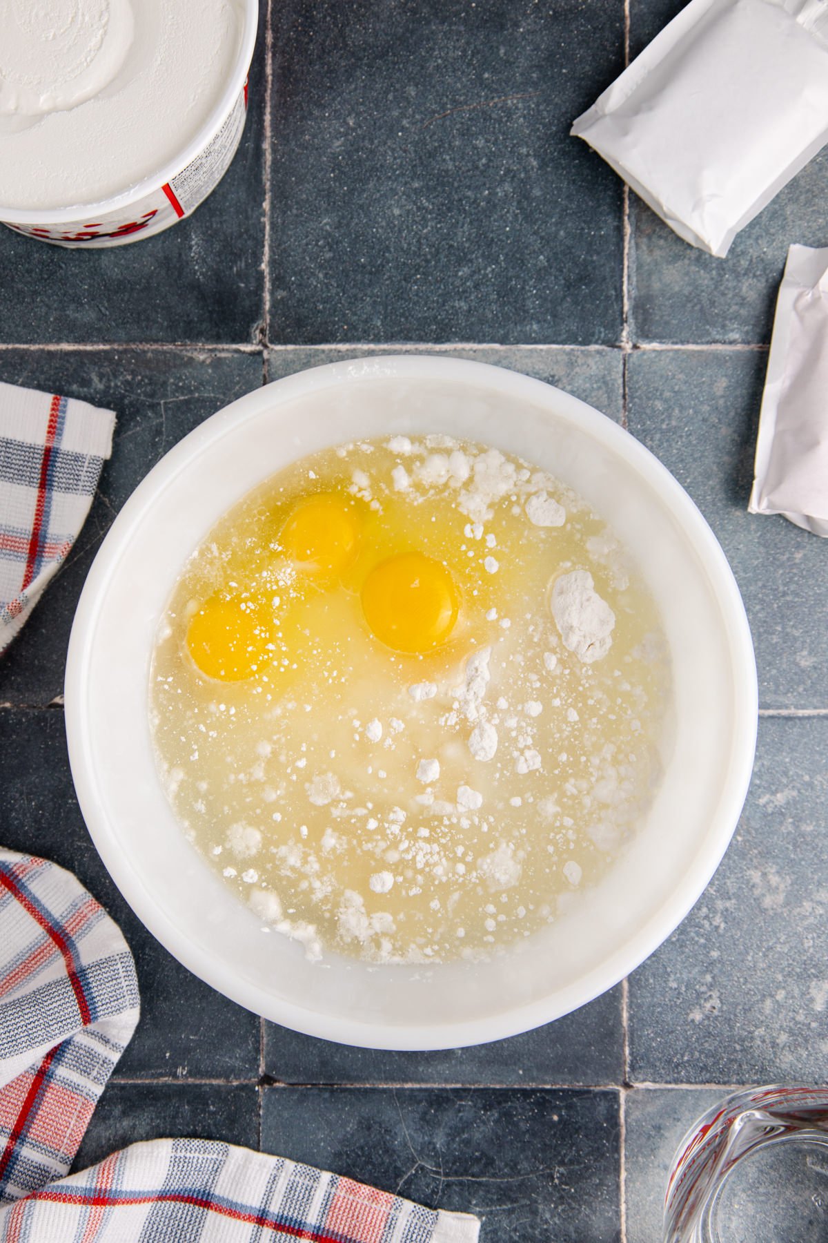 Eggs, cake batter and oil in a bowl.