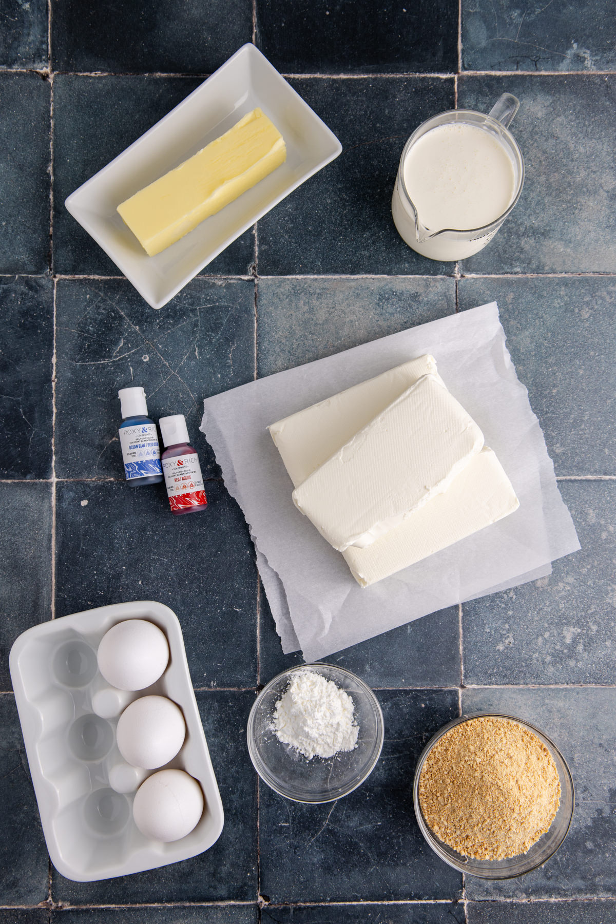 Ingredients to make a 4th of July cheesecake on a table.