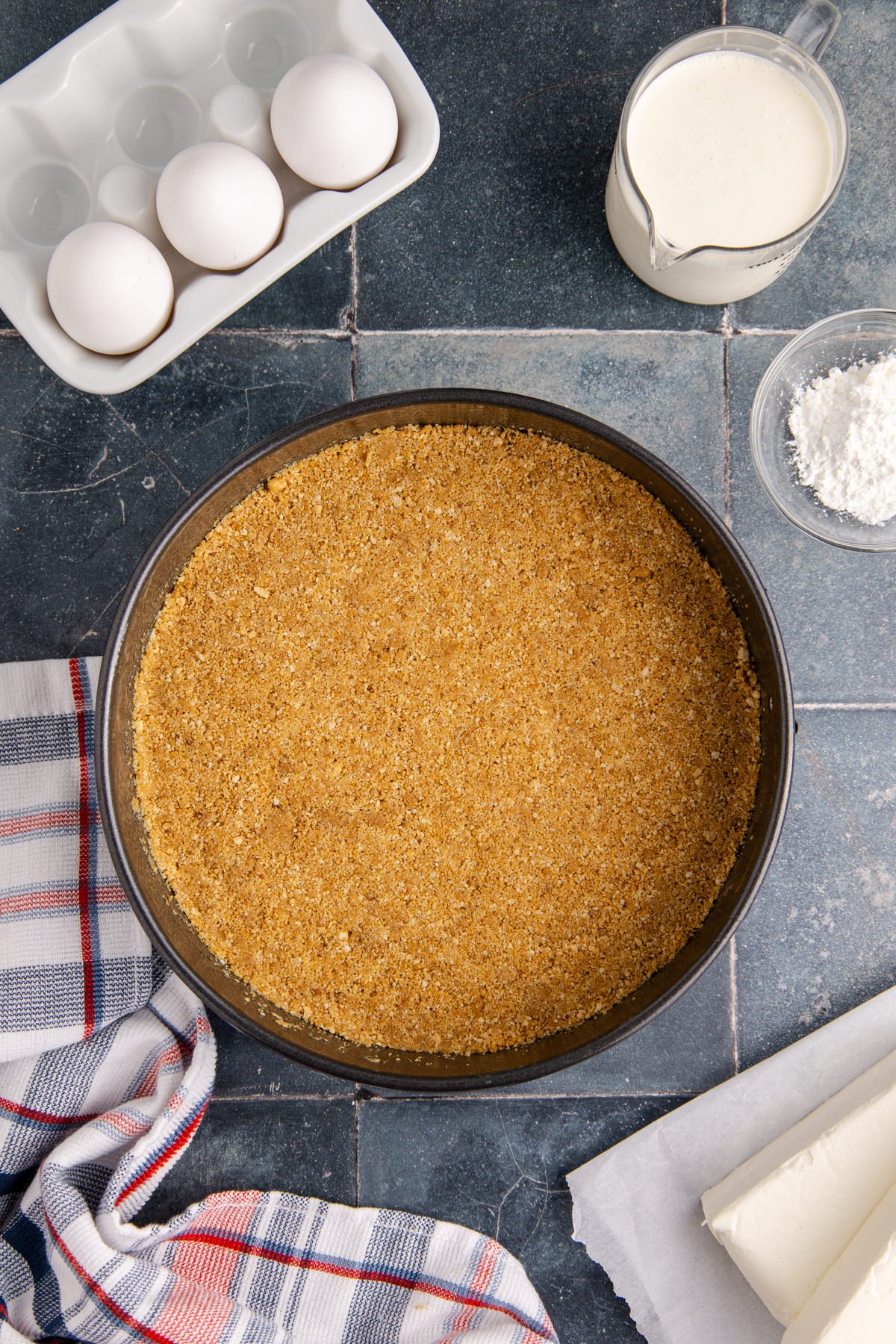Graham cracker mixture pressed into a springform pan.