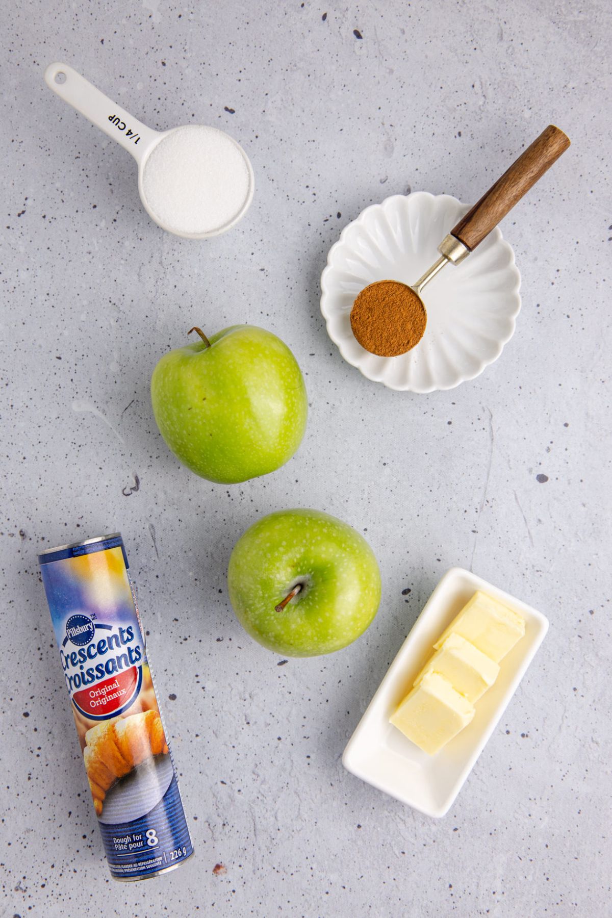 Ingredients to make this apple dumplings with crescent rolls on a table.