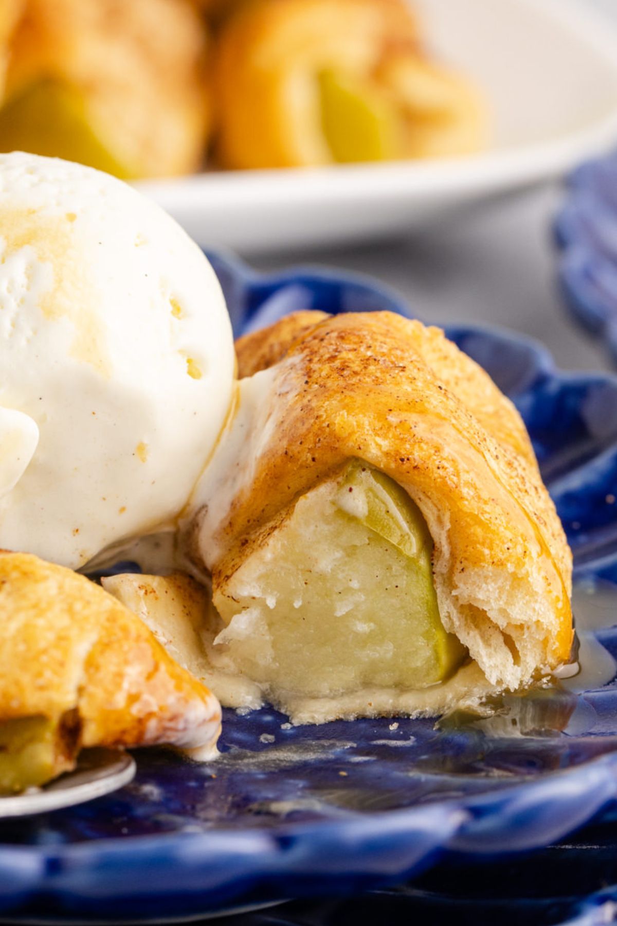 The inside of an apple wrapped in a croissant with ice cream.