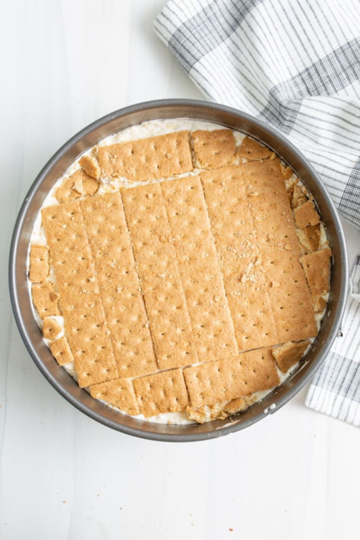 Additional layer of graham crackers around the pan.