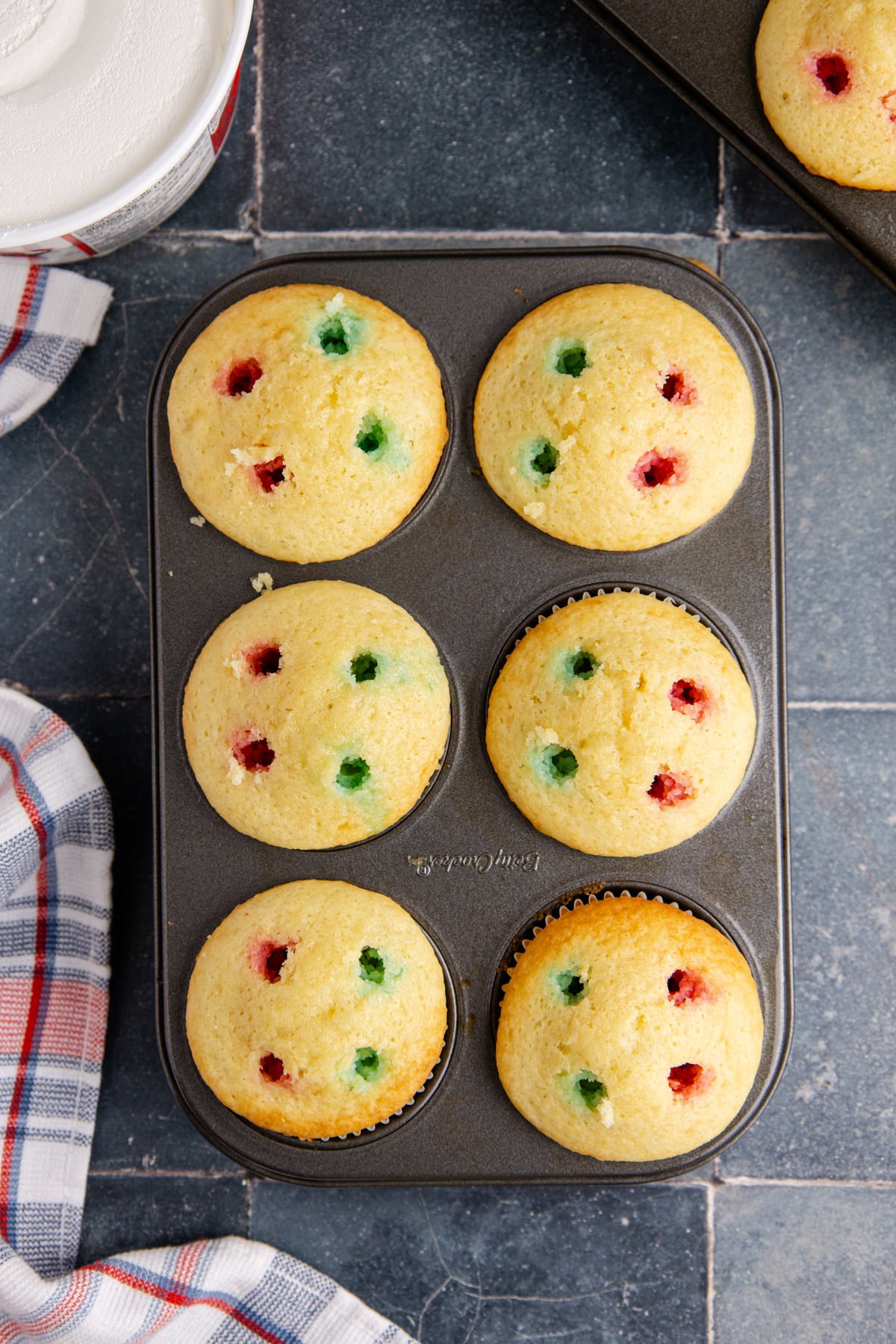 Jello mix poured into the poked holes in the cupcakes.