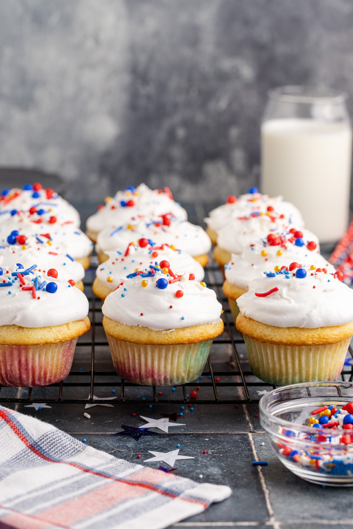 Chilled cupcakes with cool whip on top of each one.