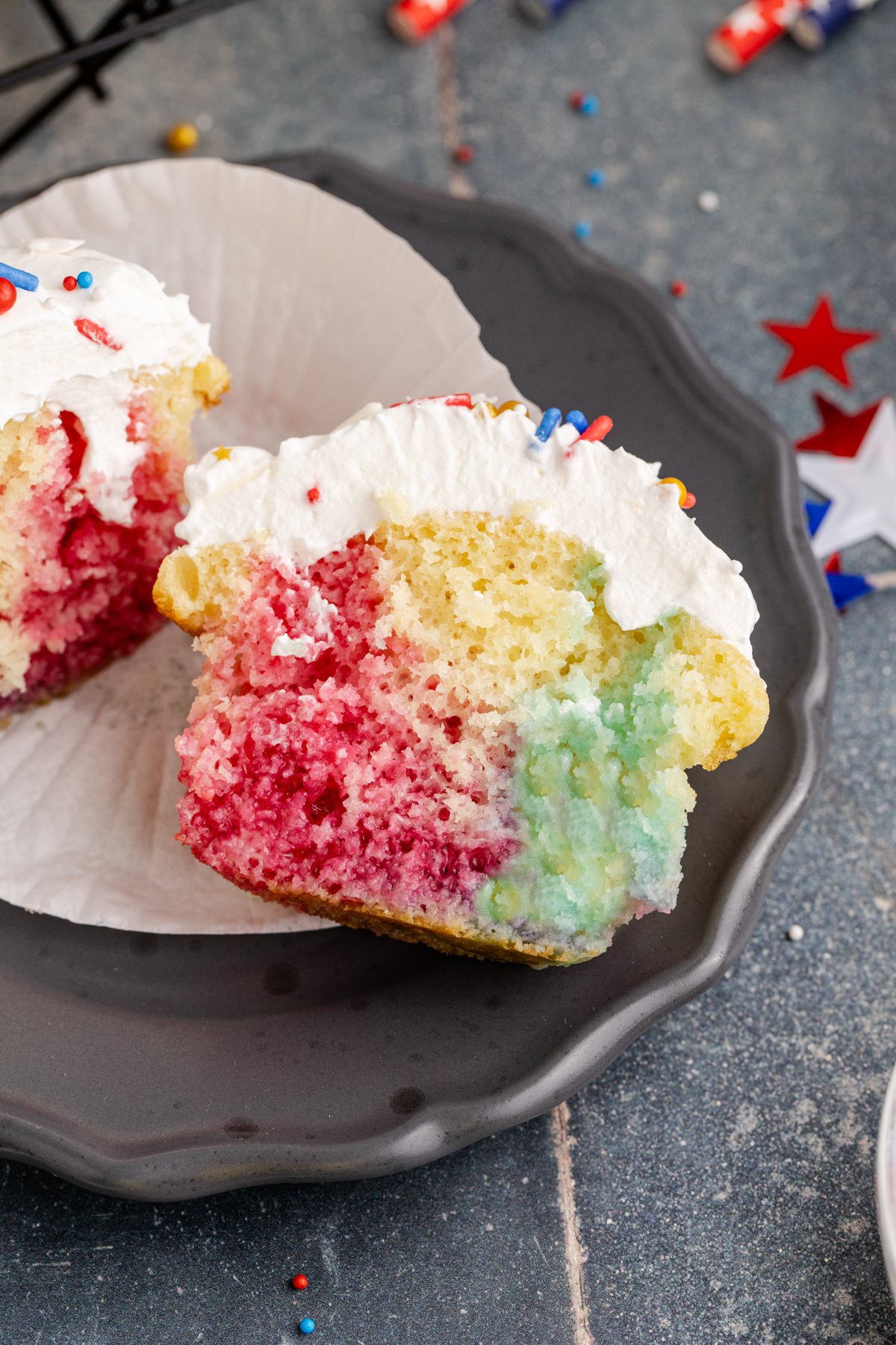 Half of a poke cake cupcake on a plate.