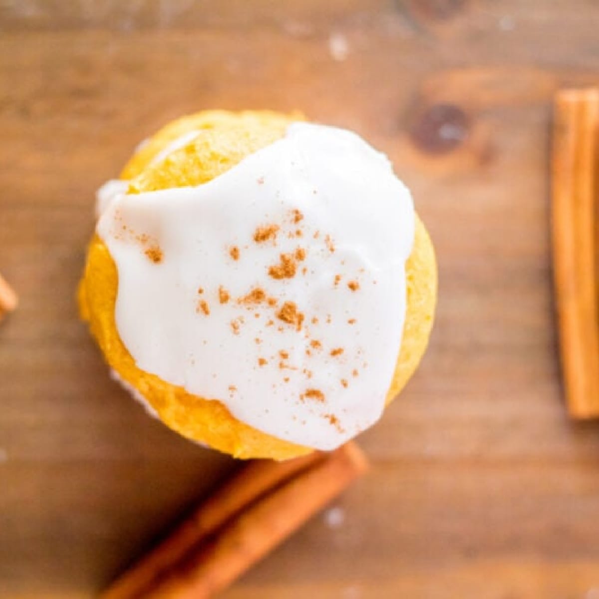 Glazed Pumpkin Cookie with cinnamon stick beside it 