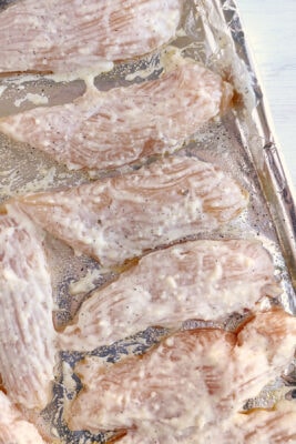 All chicken tenders are coated in the mixture and are ready for the oven.