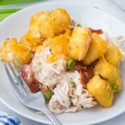 Chicken bacon ranch tater tot casserole on a plate with a fork resting to the side.