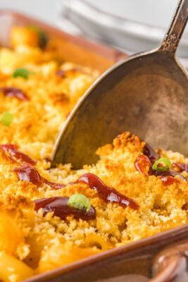 Closeup photo of a large spoon digging into the mac and cheese.