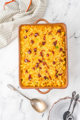 Baked mac and cheese garnished with chopped green onions.