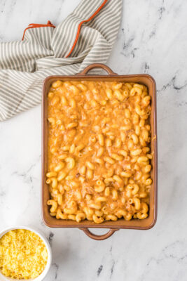 Mac and cheese poured inside a prepared pan.