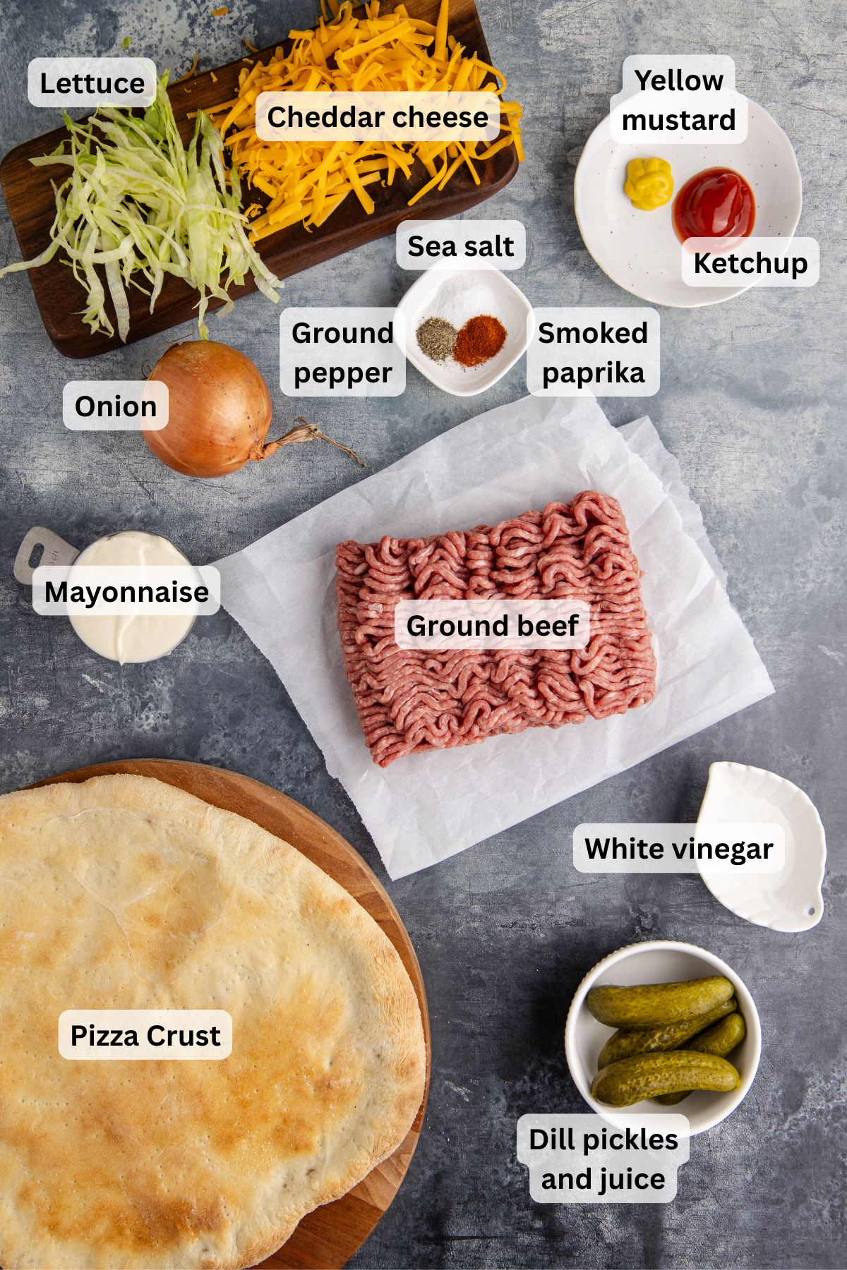 Ingredients for big mac pizza on a table.