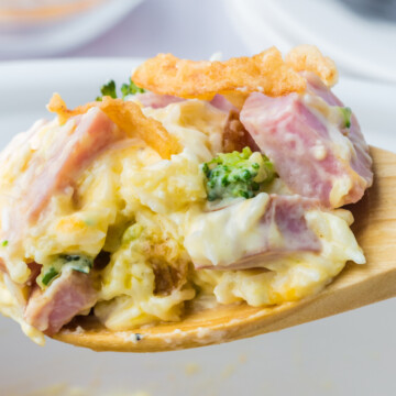 Slow cooker ham and rice casserole on a wooden spoon