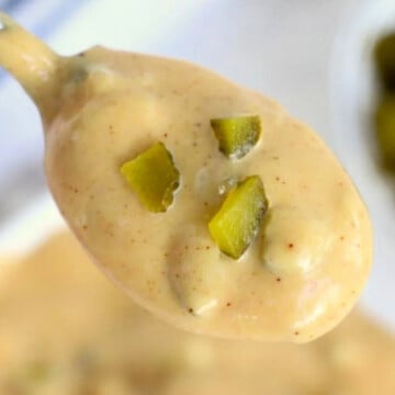 A spoonful of copycat Big Mac sauce held in the air.