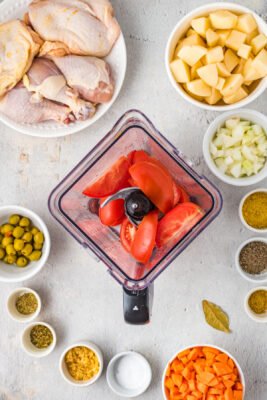Tomatoes added to a blender.